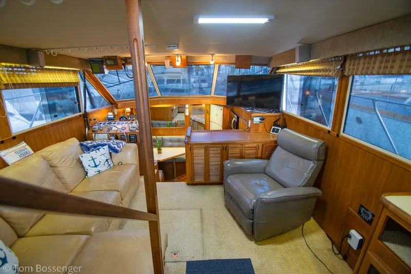 Slide: The Image of Interior of a 1986 Chris-Craft Corinthian yacht with cozy seating and wooden accents. - 6