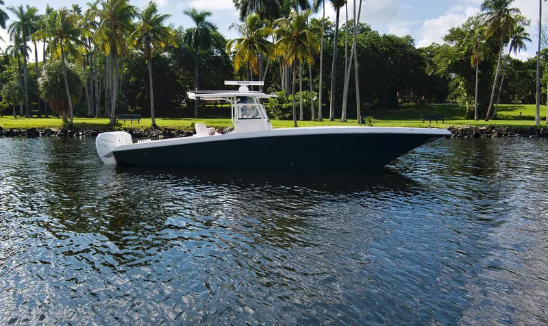 The Image of 2016 Fountain 38 CC Tournament Edition boat on calm water with palm trees in the background. - 0