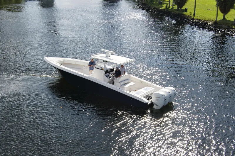 Slide: The Image of 2016 Fountain 38 CC Tournament Edition boat cruising on a calm river. - 12