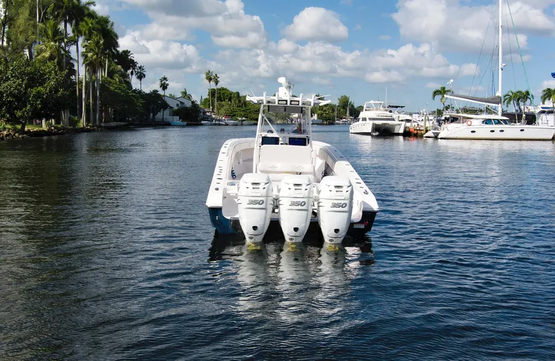 Slide: The Image of 2016 Fountain 38 CC Tournament Edition boat with quad outboard engines on a calm waterway. - 13