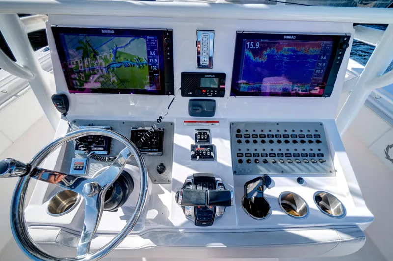 Slide: The Image of 2016 Fountain 38 CC Tournament Edition boat dashboard with advanced navigation and control systems. - 20
