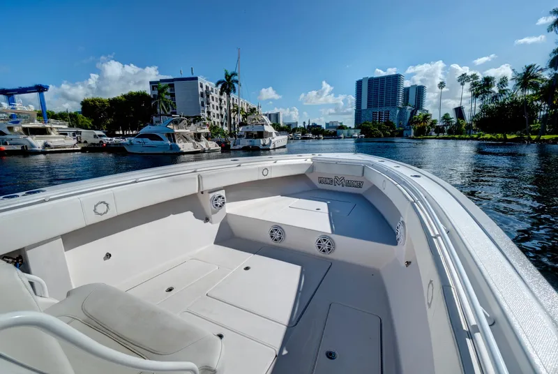 Slide: The Image of 2016 Fountain 38 CC Tournament Edition boat docked in a marina with cityscape background. - 22
