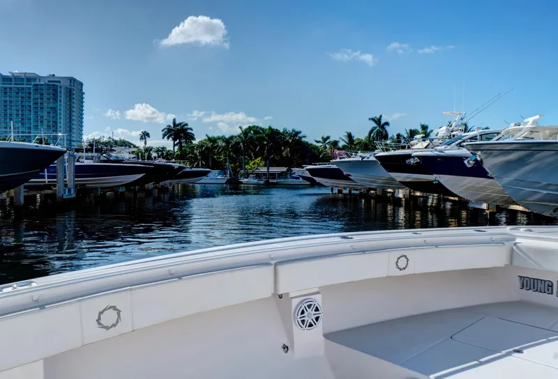 Slide: The Image of 2016 Fountain 38 CC Tournament Edition boat docked in a marina with other boats. - 24