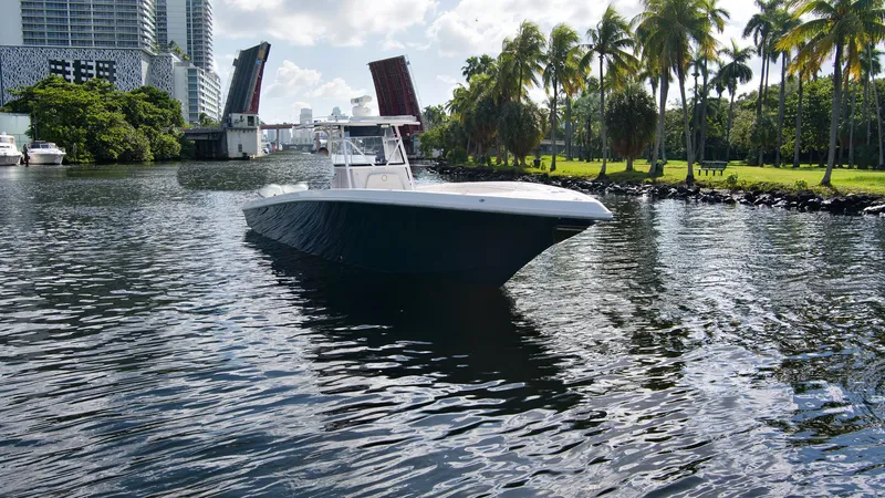 Slide: The Image of 2016 Fountain 38 CC Tournament Edition boat cruising on a river with a drawbridge in the background. - 3