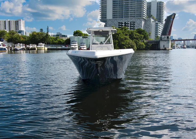 Slide: The Image of 2016 Fountain 38 CC Tournament Edition boat on urban waterway with cityscape background. - 6
