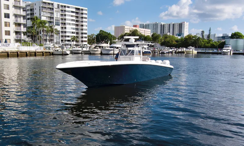 Slide: The Image of 2016 Fountain 38 CC Tournament Edition boat on water near urban marina. - 7