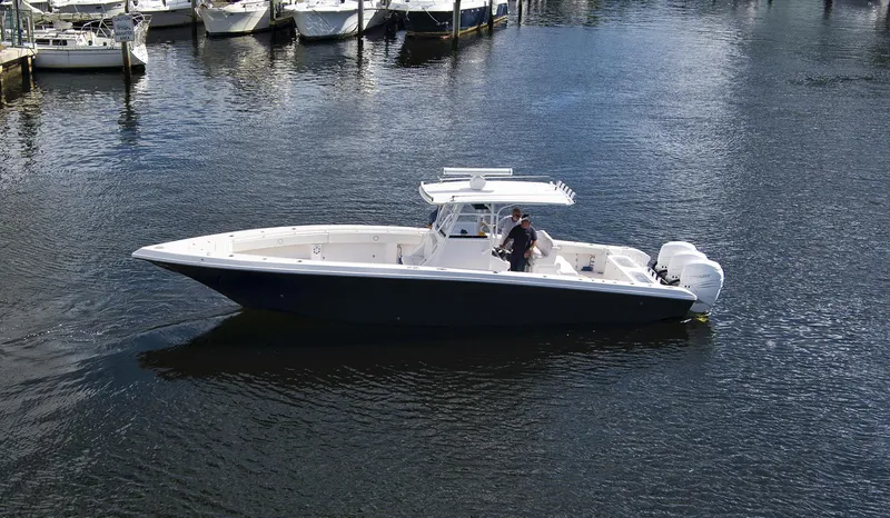 Slide: The Image of 2016 Fountain 38 CC Tournament Edition boat on water near marina. - 9