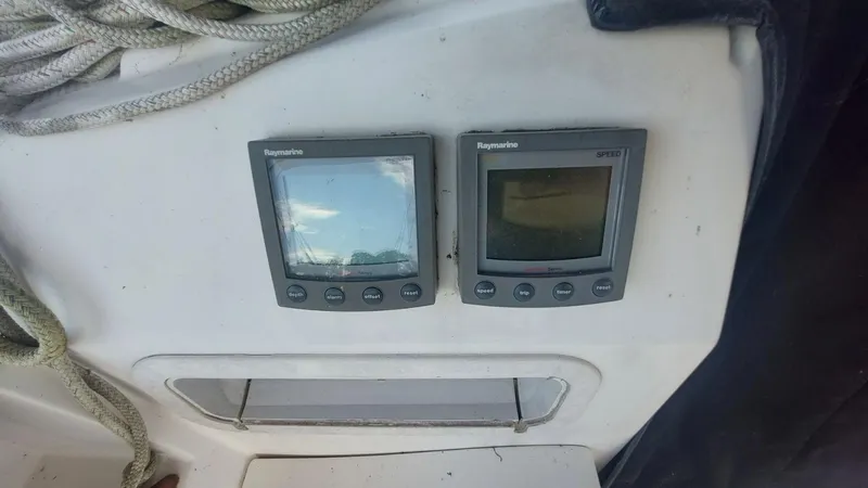 Slide: The Image of Two Raymarine displays on a 1987 Hunter 34 sailboat dashboard. - 13