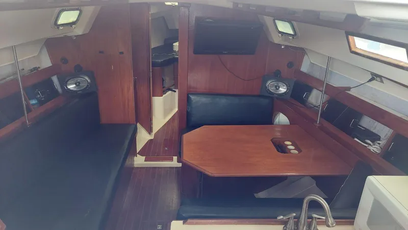 Slide: The Image of Interior of 1987 Hunter 34 sailboat with wooden furnishings and seating area. - 17
