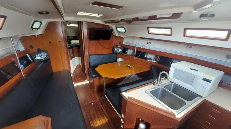 Slide: The Image of Interior of a 1987 Hunter 34 sailboat with kitchen and seating area. - 2