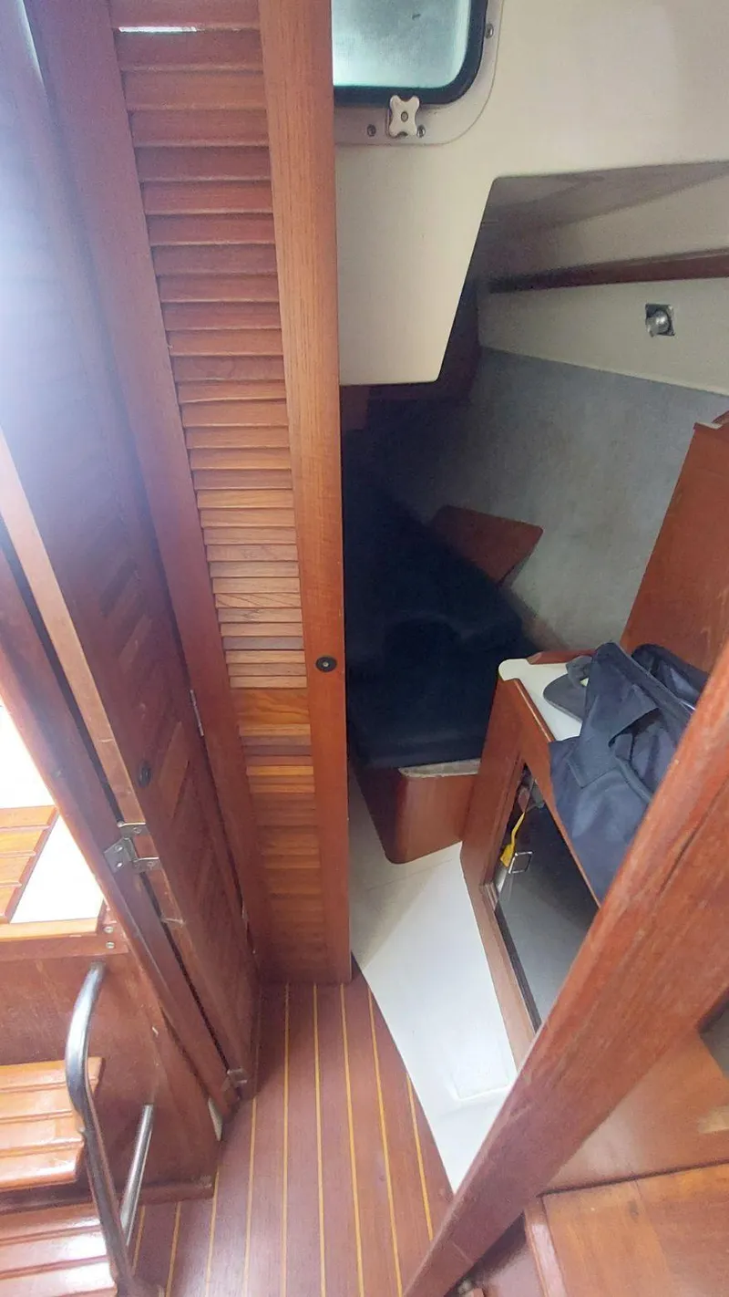 Slide: The Image of Interior of 1987 Hunter 34 sailboat with wooden finishes and compact cabin space. - 22