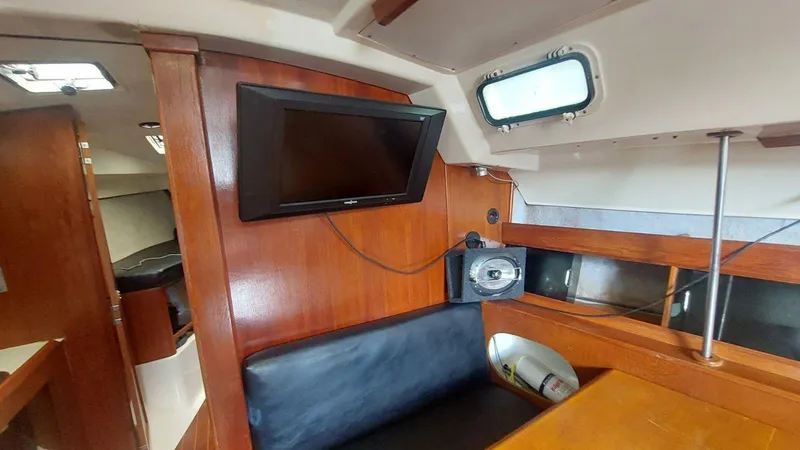 Slide: The Image of Interior of 1987 Hunter 34 sailboat with TV and seating area. - 24