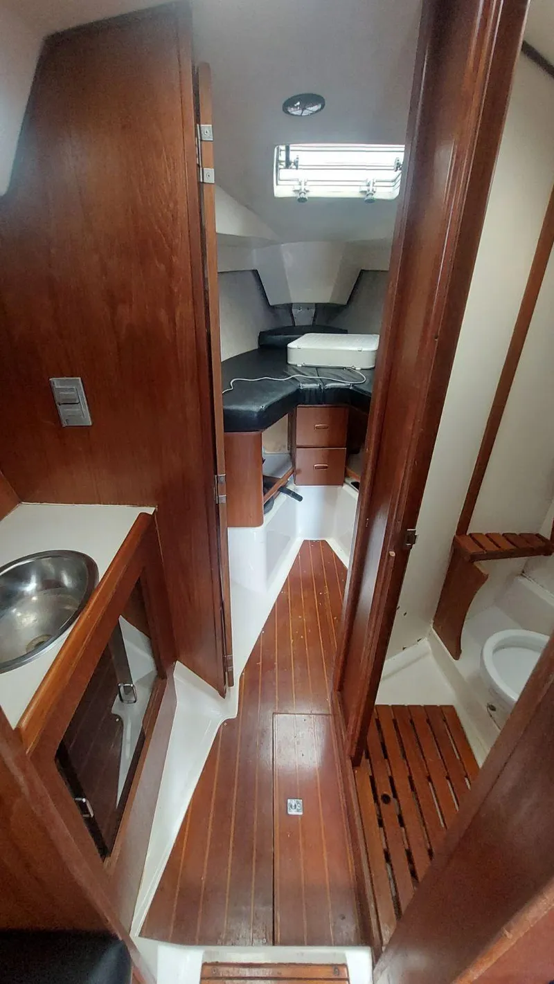 Slide: The Image of Interior of 1987 Hunter 34 sailboat with wood finish and compact layout. - 3