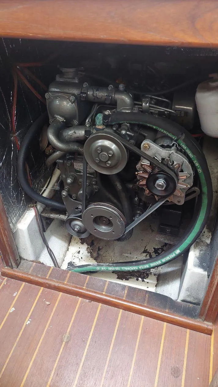 Slide: The Image of Engine compartment of a 1987 Hunter 34 sailboat, showcasing mechanical components. - 32