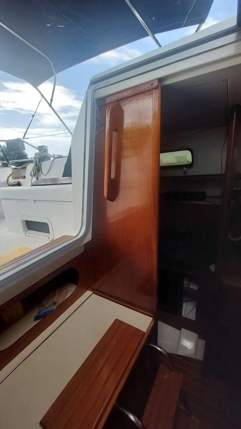 Slide: The Image of 1987 Hunter 34 sailboat interior with wooden finish and open hatch. - 35