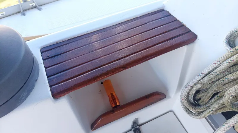 Slide: The Image of Wooden step on 1987 Hunter 34 sailboat deck with coiled rope nearby. - 42