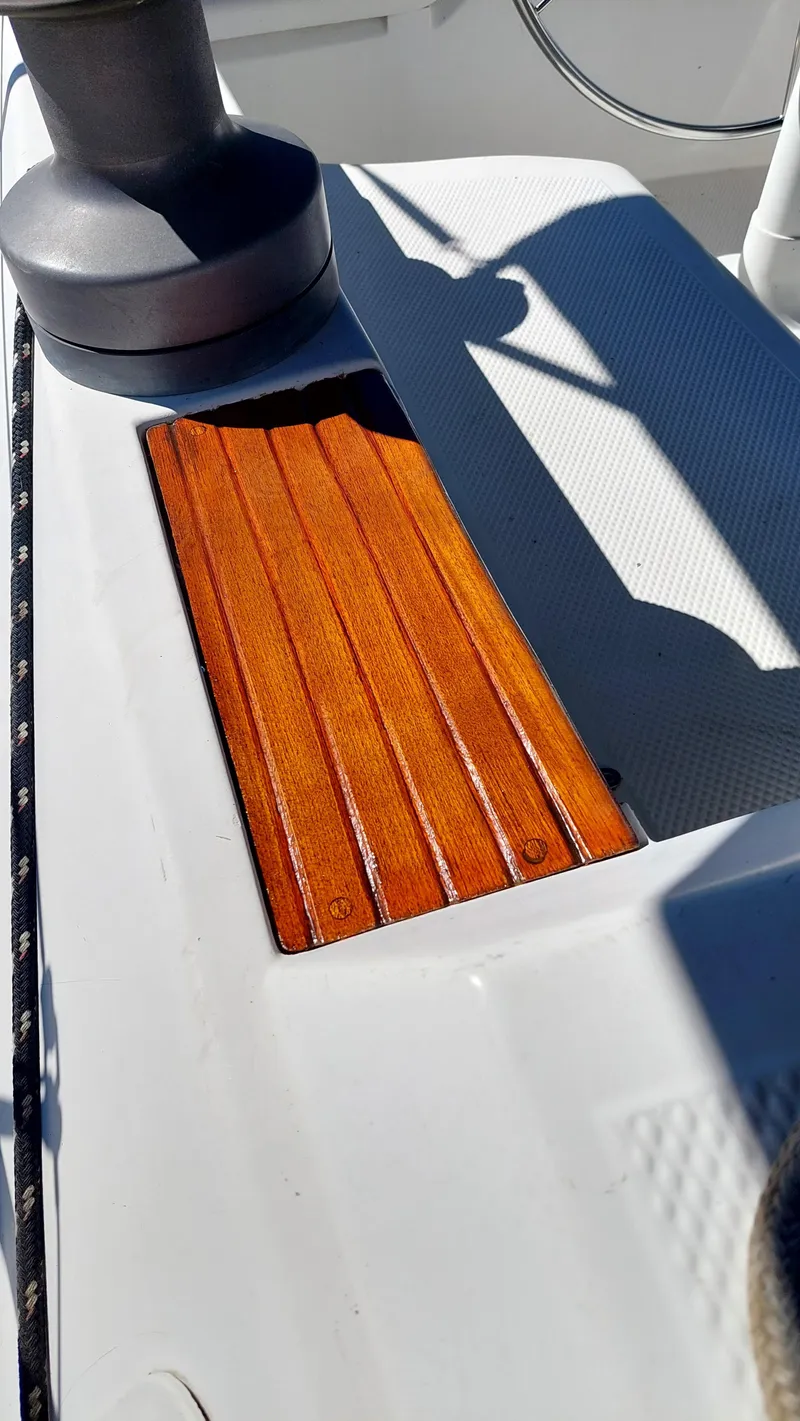 Slide: The Image of 1987 Hunter 34 sailboat deck with wooden panel and winch. - 48