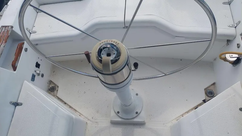 Slide: The Image of Cockpit of 1987 Hunter 34 sailboat featuring a large steering wheel. - 7