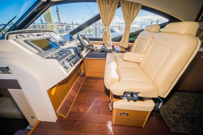 Slide: The Image of 2015 Sea Ray Sundancer 510 helm with leather seats and advanced navigation controls. - 12