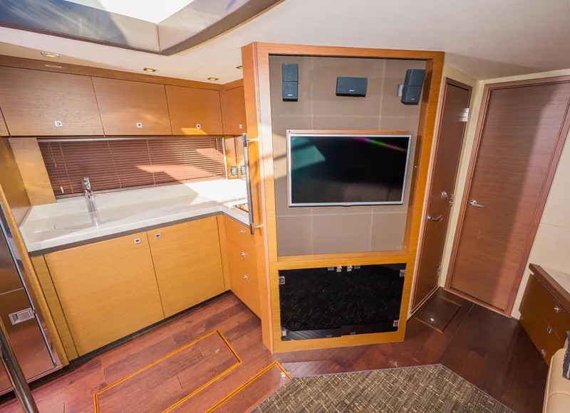 Slide: The Image of 2015 Sea Ray Sundancer 510 interior with modern kitchen and entertainment center. - 14