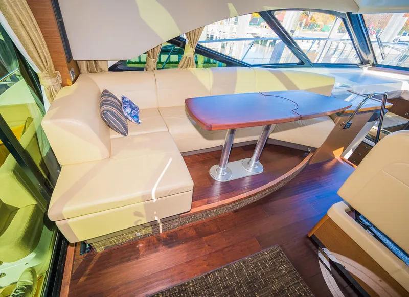 Slide: The Image of Luxurious interior of 2015 Sea Ray Sundancer 510 with leather seating and wooden table. - 15