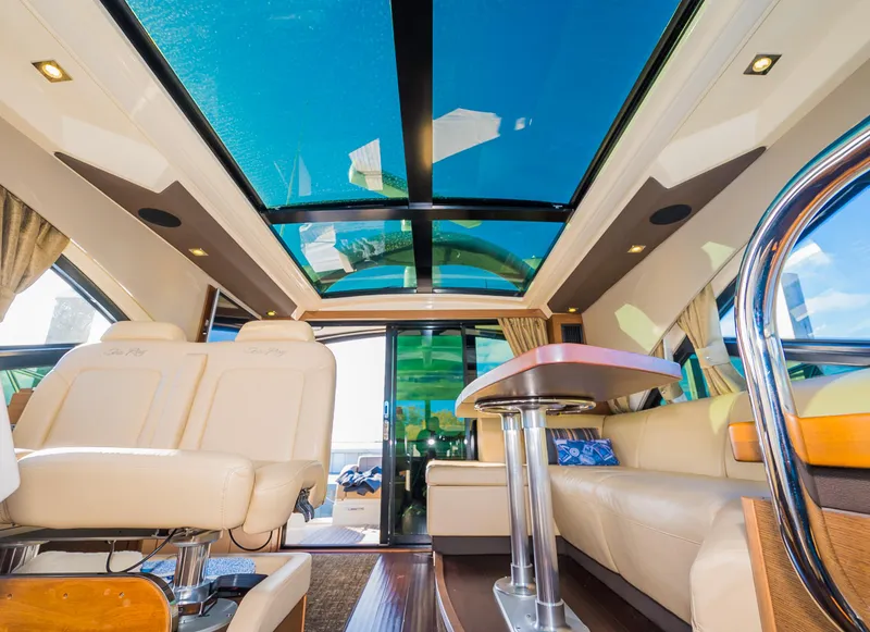 Slide: The Image of Interior of 2015 Sea Ray Sundancer 510 yacht with luxurious seating and panoramic windows. - 18