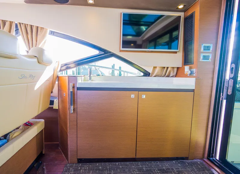 Slide: The Image of Interior of 2015 Sea Ray Sundancer 510 yacht with TV and wooden cabinetry. - 31