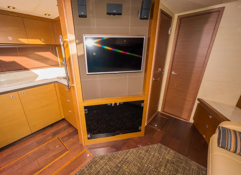 Slide: The Image of 2015 Sea Ray Sundancer 510 interior with TV, wooden cabinets, and modern design. - 32
