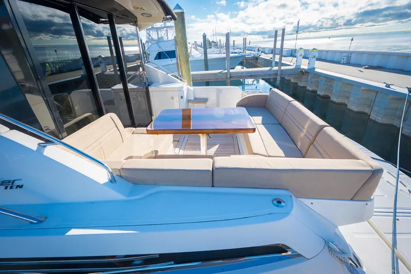 Slide: The Image of 2015 Sea Ray Sundancer 510 yacht with outdoor seating and table at the dock. - 9