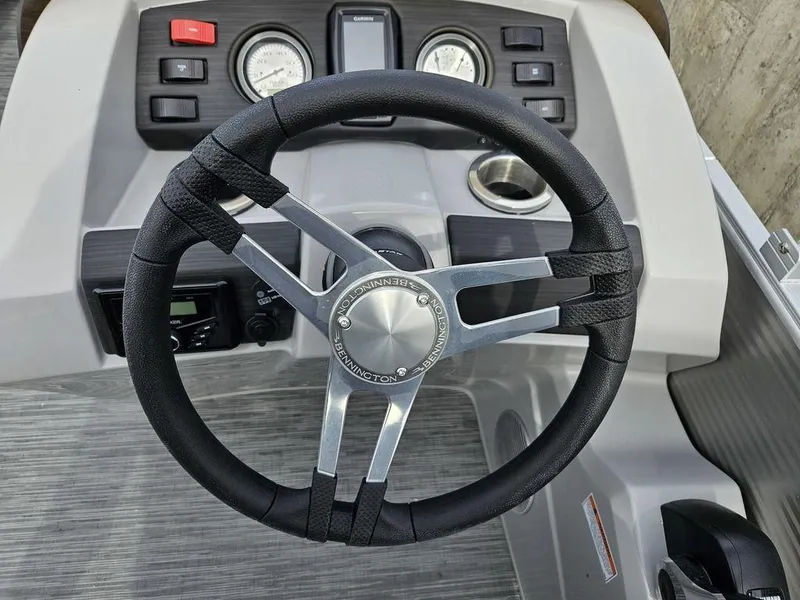 Slide: The Image of 2023 Bennington 21 SXL boat steering wheel and dashboard controls. - 10