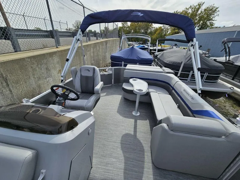 Slide: The Image of 2023 Bennington 21 SXL pontoon boat with spacious seating and canopy. - 11