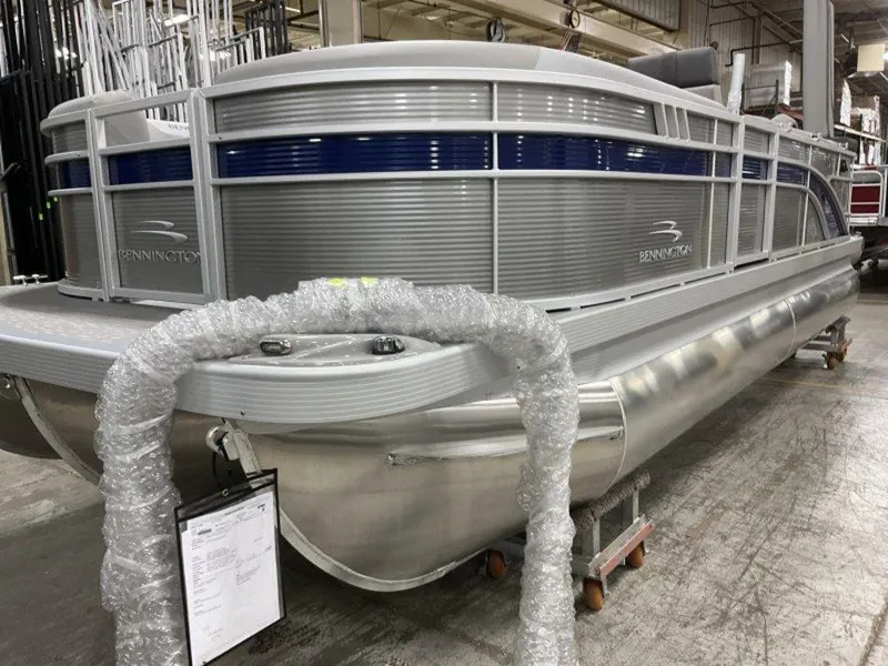 Slide: The Image of 2023 Bennington 21 SXL pontoon boat in a warehouse. - 12