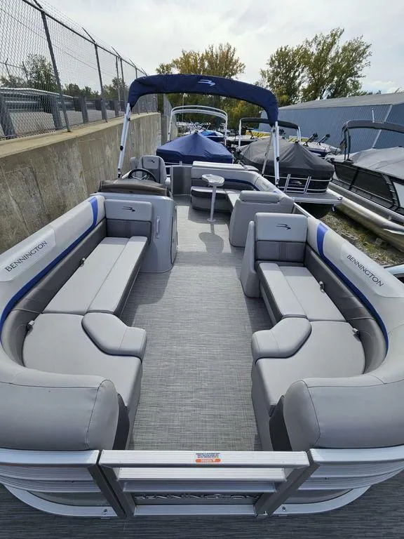 Slide: The Image of 2023 Bennington 21 SXL pontoon boat with spacious seating and canopy. - 5