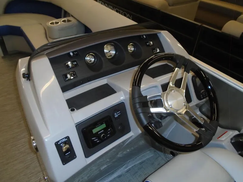 Slide: The Image of 2023 Bennington 22 LSB boat dashboard with steering wheel and control panel. - 11