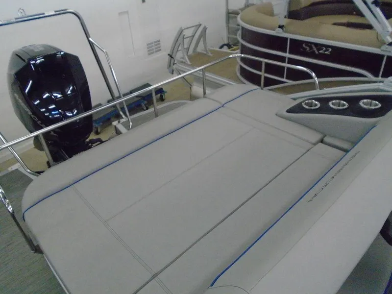 Slide: The Image of 2023 Bennington 22 LSB pontoon boat with rear seating and outboard motor. - 12