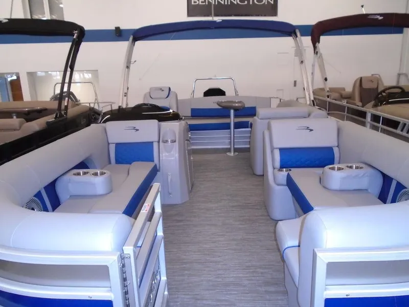 Slide: The Image of 2023 Bennington 22 LSB pontoon boat interior with blue and gray seating. - 13