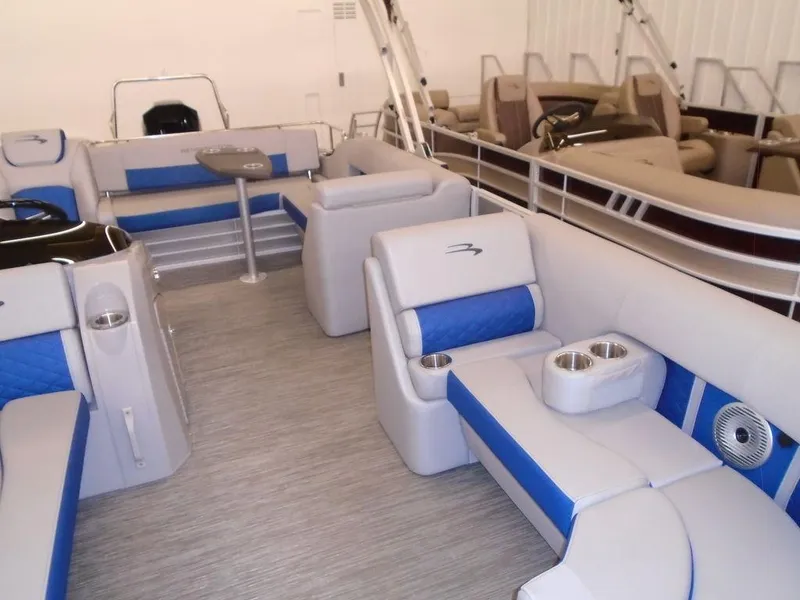 Slide: The Image of 2023 Bennington 22 LSB pontoon boat interior with blue and gray seating. - 18
