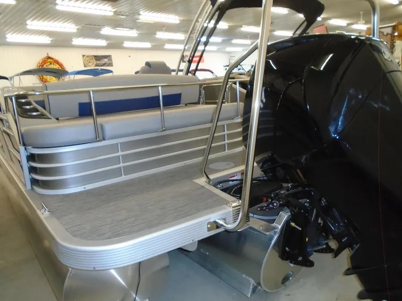 Slide: The Image of 2023 Bennington 22 LSB pontoon boat rear view with motor and seating. - 20