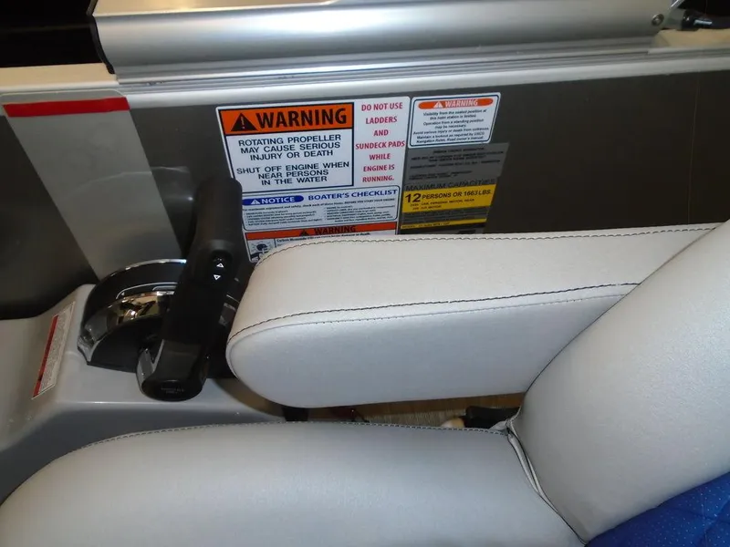 Slide: The Image of Control panel and warning labels on a 2023 Bennington 22 LSB boat. - 22