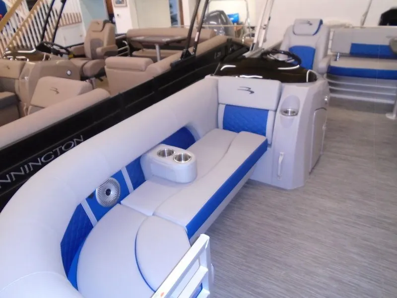 Slide: The Image of 2023 Bennington 22 LSB pontoon boat interior with blue and gray seating. - 28