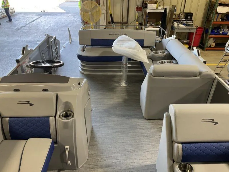 Slide: The Image of 2023 Bennington 22 LSB pontoon boat interior with blue and gray seating. - 29