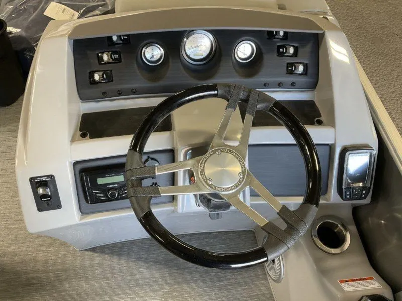 Slide: The Image of 2023 Bennington 22 LSB boat dashboard with steering wheel and control panel. - 4