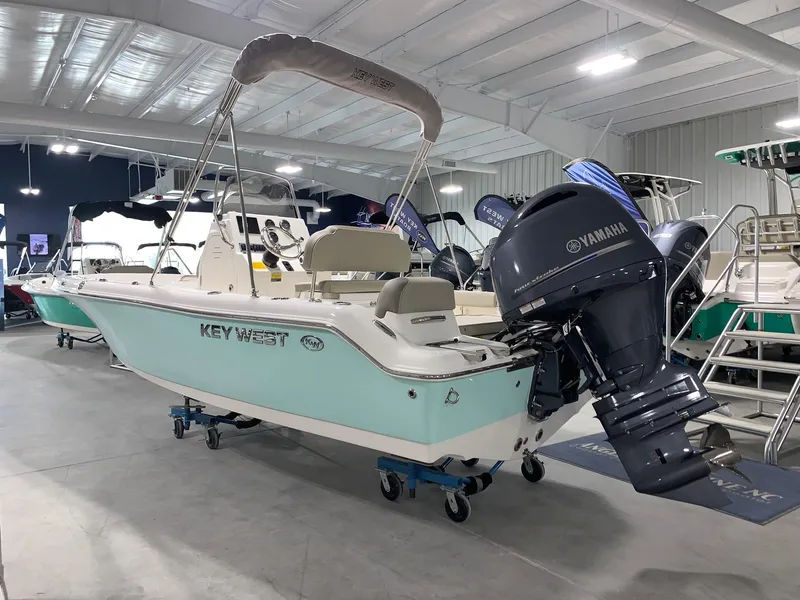 Slide: The Image of 2024 Key West 189 FS boat with Yamaha outboard motor in showroom. - 2