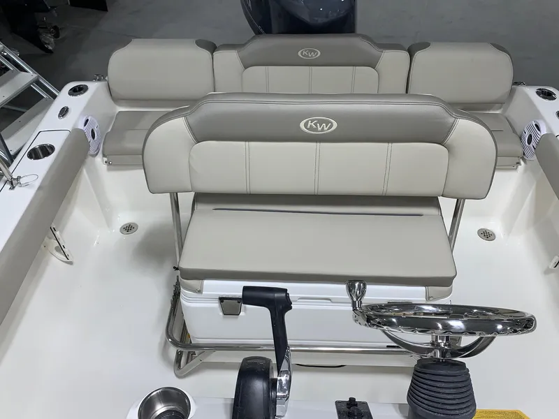 Slide: The Image of 2024 Key West 189 FS boat interior with cushioned seating and steering wheel. - 9