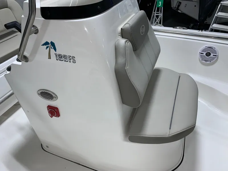 Slide: The Image of 2024 Key West 189 FS boat interior with cushioned seating and control panel. - 11