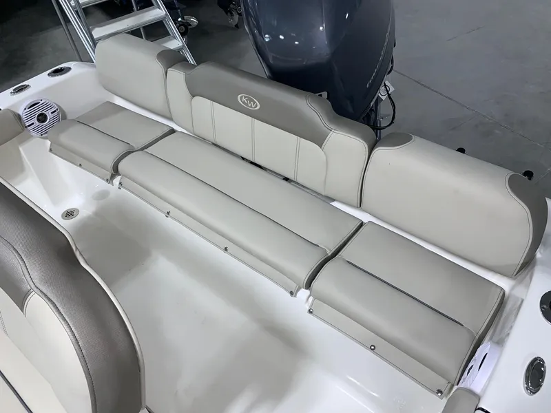Slide: The Image of 2024 Key West 189 FS boat interior seating with beige cushions. - 4