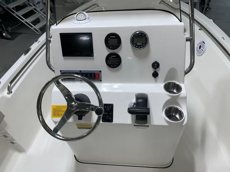 Slide: The Image of 2024 Key West 189 FS boat console with steering wheel, gauges, and controls. - 7