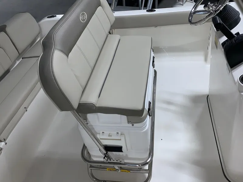 Slide: The Image of 2024 Key West 189 FS boat interior with cushioned seating and storage. - 9