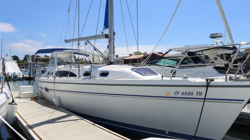 The Image of 2010 Catalina 375 sailboat docked at marina under clear blue sky. - 0
