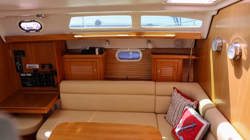 Slide: The Image of Interior of 2010 Catalina 375 sailboat with cozy seating and wooden cabinetry. - 10